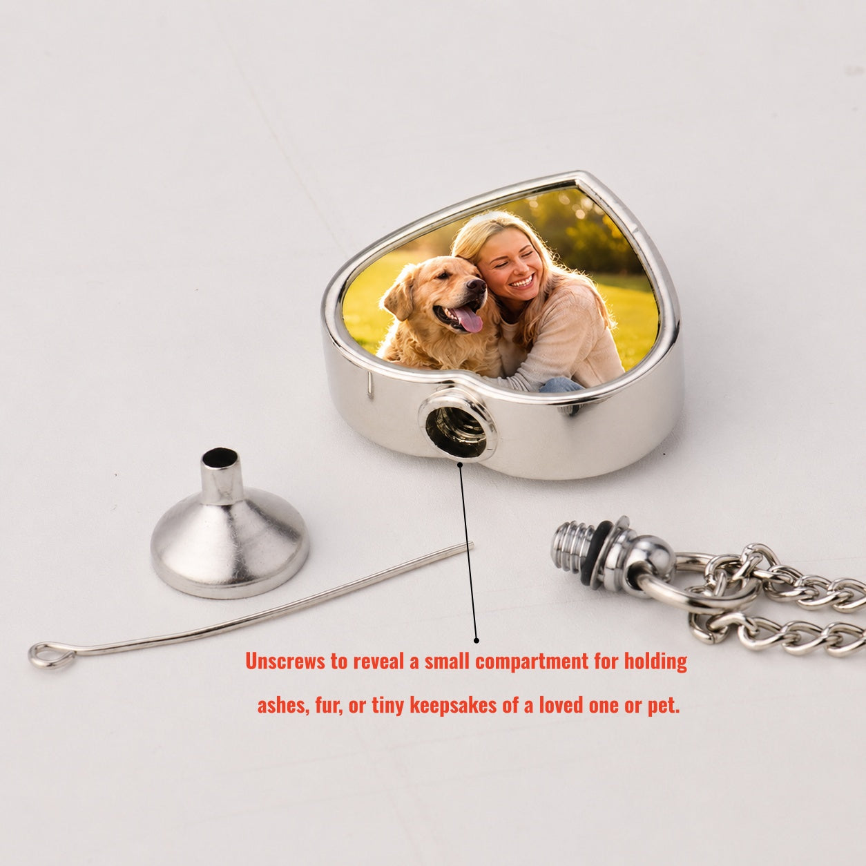 Heart-shaped urn with a photo of a woman and dog, unscrews to reveal a small compartment.