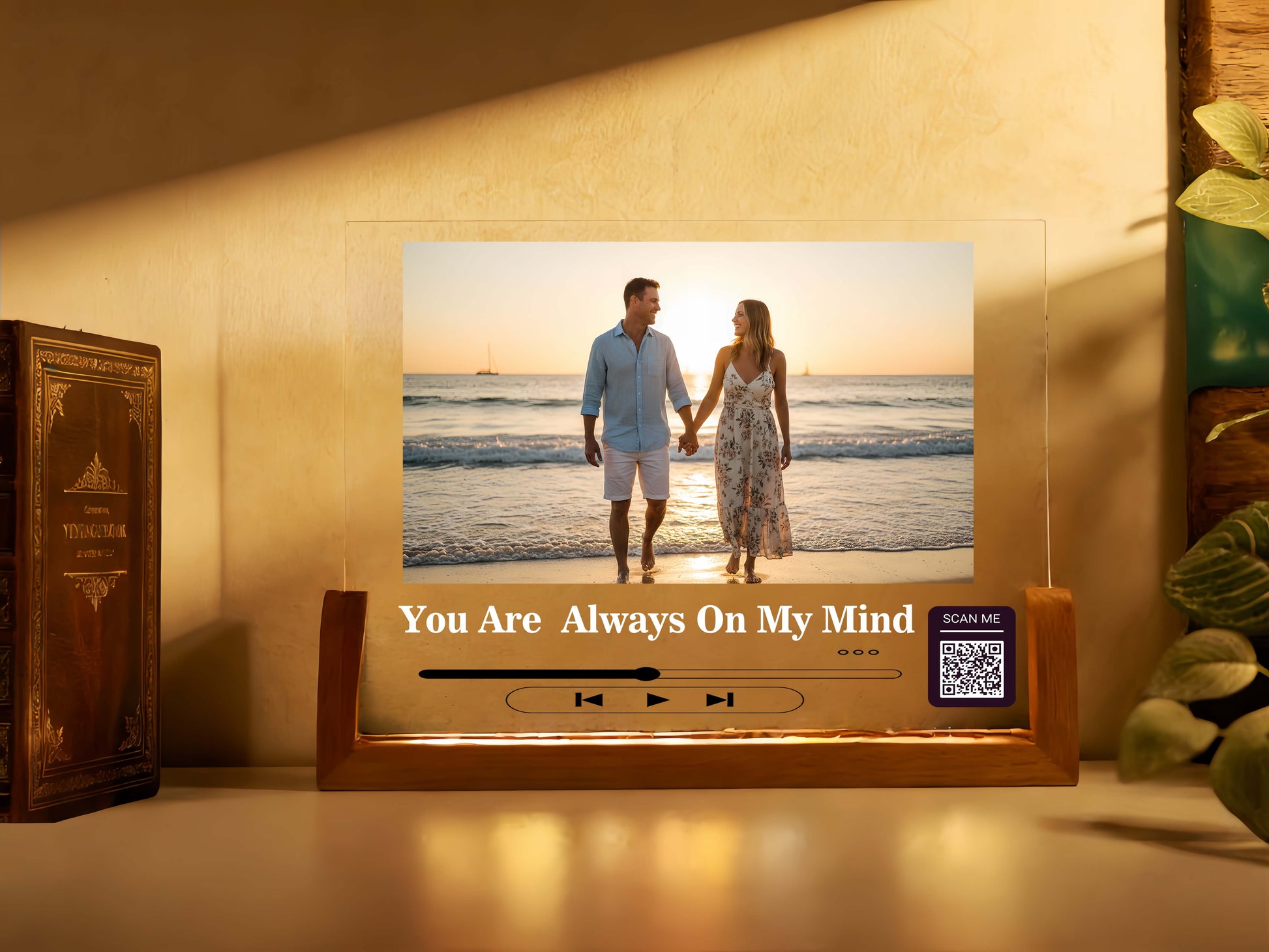 Decorative photo frame with a couple on a beach and text 'You Are Always On My Mind' on a wooden surface.