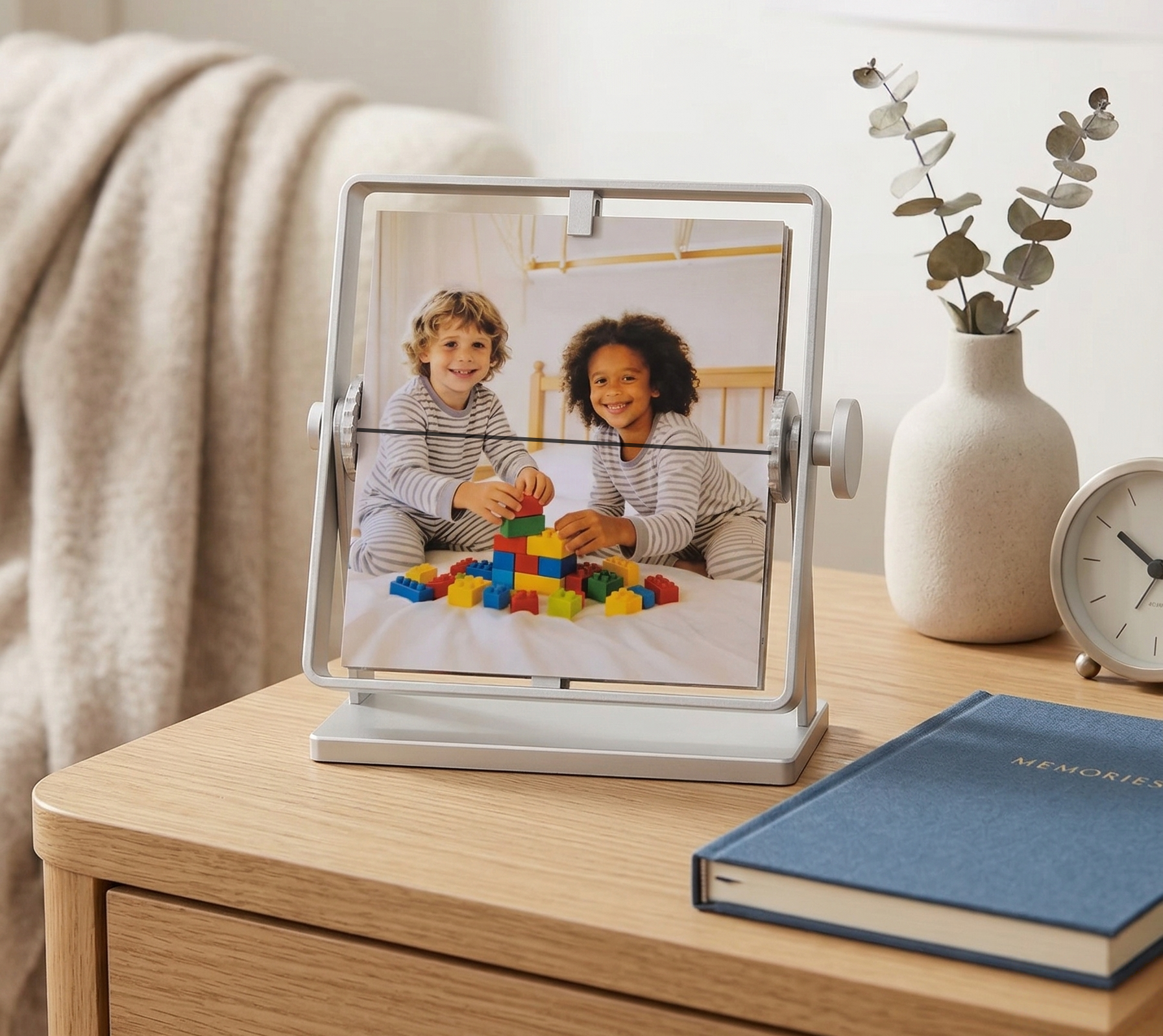 Personalized family gift for mom or wife: Silver rotating metal photo frame showing happy children playing. A custom tabletop photo album for bedroom nightstand decor.